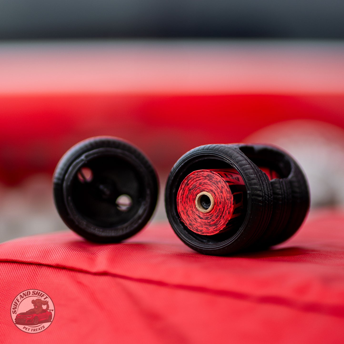 Two black tire covers with red and black striped inner lining, displayed on a red fabric surface. A circular 'Port & Shelf by Truck' logo is visible in the bottom-left corner.