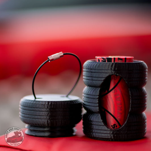Sniff and Shift tire stack poop bag holder with the top tire unscrewed and a bag roll inside