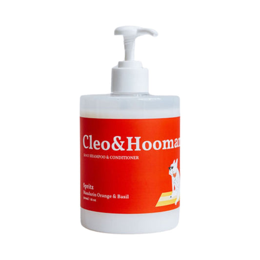 Cleo&Hooman Spritz dog shampoo and conditioner in a white pump bottle with an orange label showing a cartoon dog in sunglasses