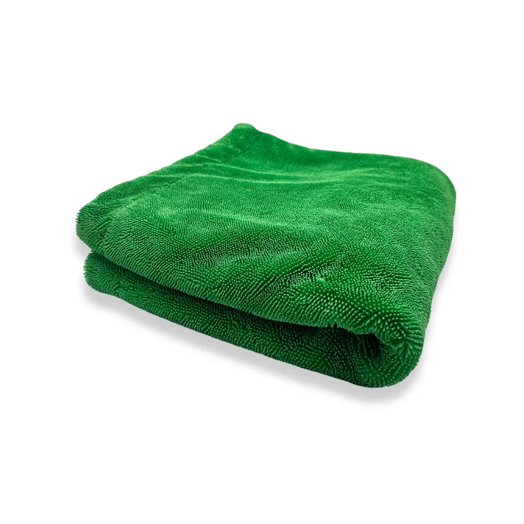 Folded green 3D HYDRO-FIL microfiber drying towel photographed on a white background