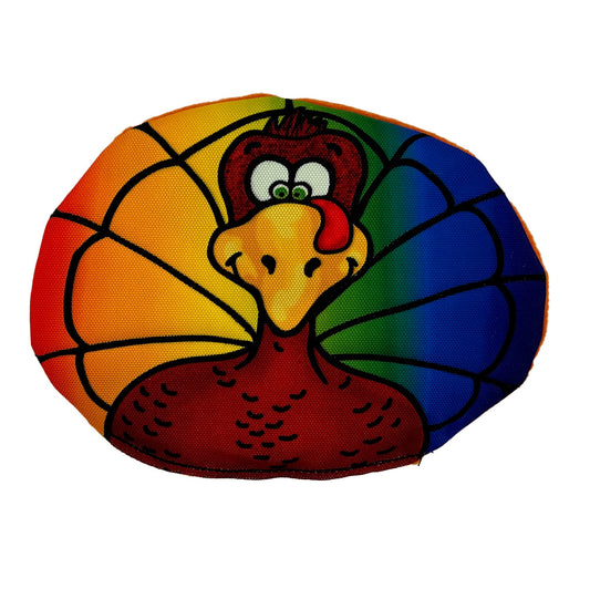 Rainbow Turkleton dog toy by American Dog, an oval cartoon turkey printed on a rainbow 1000D nylon background