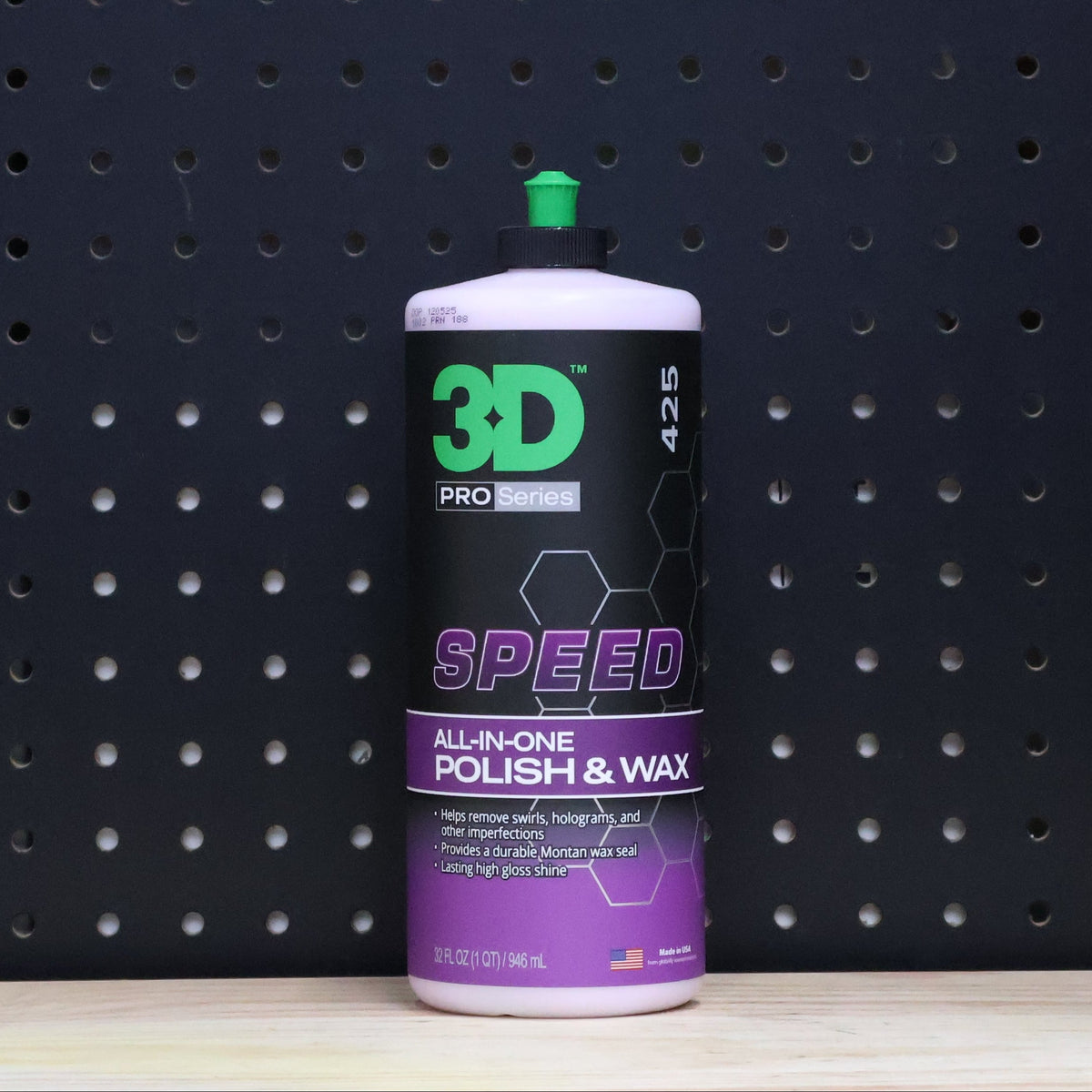 3D SPEED 32 oz bottle, purple and black all in one polish and wax label with a green cap, against a dark pegboard wall