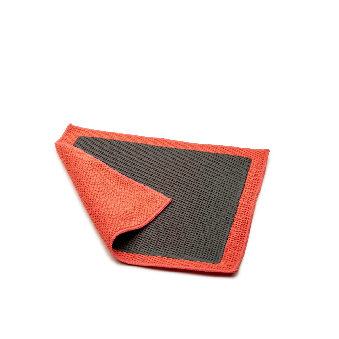 P&S Reset clay towel with an orange microfiber side folded back over a dark gray rubber polymer face